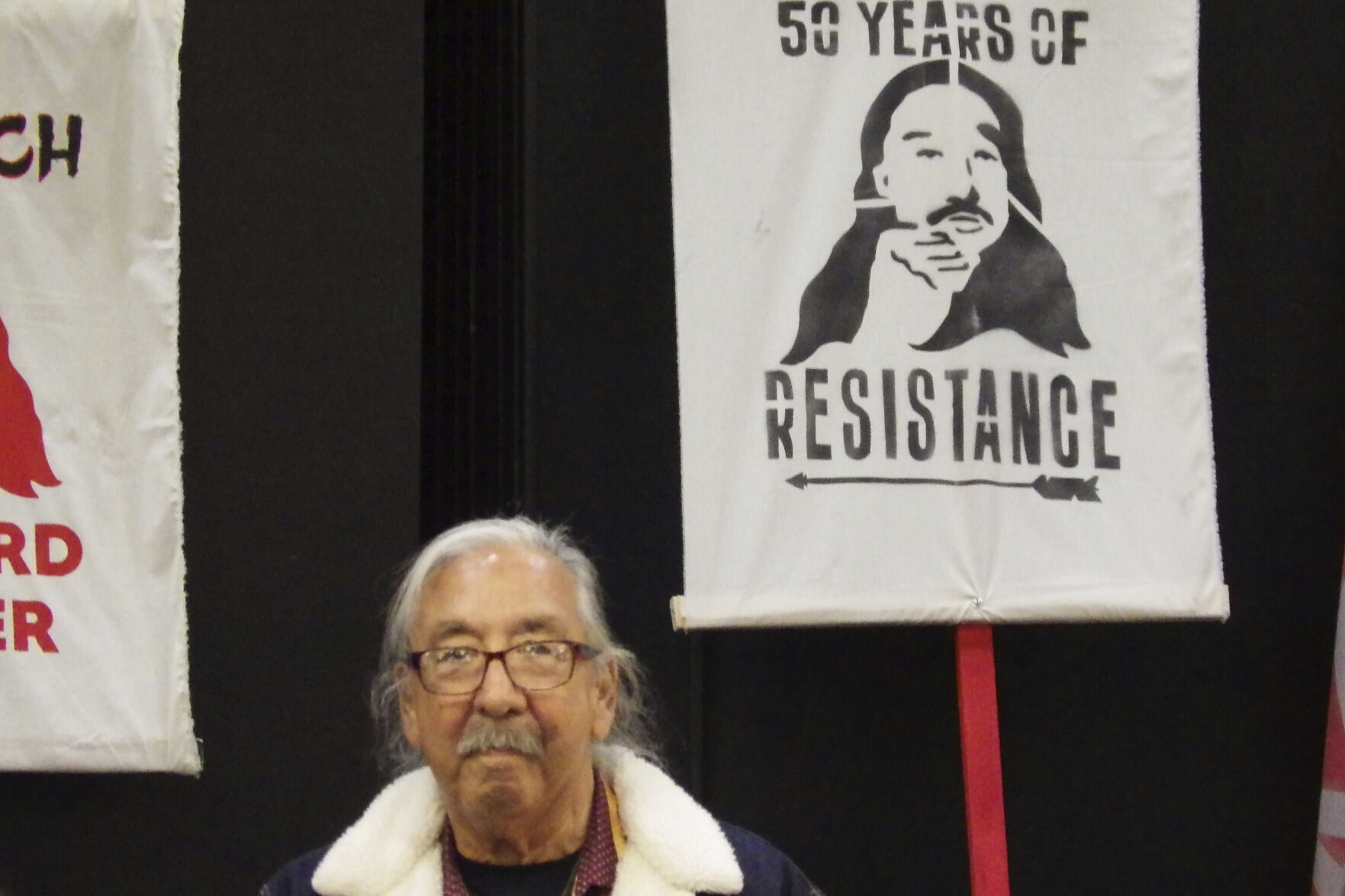 Leonard Peltier, center, a Native American activist released from a Florida prison where he had been serving a life sentence in the 1975 killings of two FBI agents, listens during a welcome event, Wednesday, Feb. 19, 2025, at the Sky Dancer Casino Resort near Belcourt, N.D., on the Turtle Mountain Reservation. (AP Photo/Jack Dura)